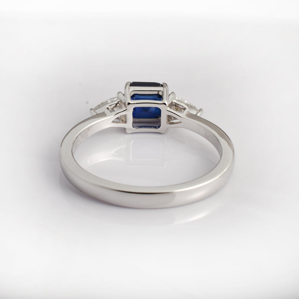 Blue sapphire engagement ring in 14K white gold with octagon cut sapphire and diamond side stones, art deco style by Ganpati