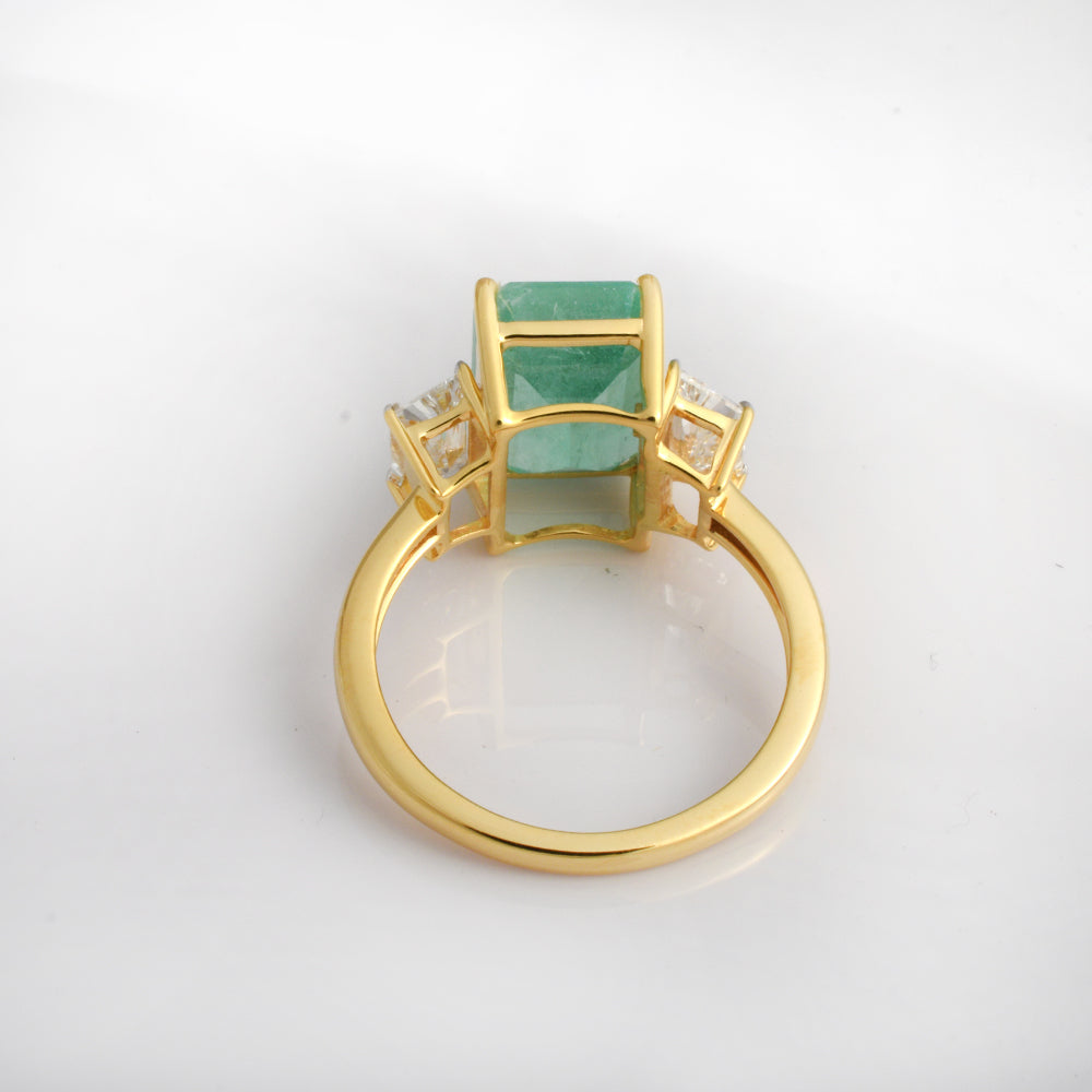 Emerald cut lab-grown diamond engagement ring in 14K yellow gold with three-stone design by Ganpati.