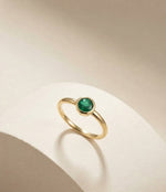 Natural emerald bezel ring by Ganpati with gold vermeil and sterling silver, features a round emerald solitaire in a minimalist design