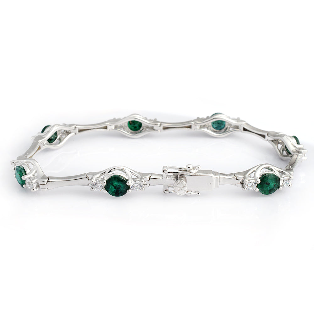 A silver-toned tennis bracelet featuring round green emerald-cut gemstones and small clear accent stones, displayed on a clean white background.