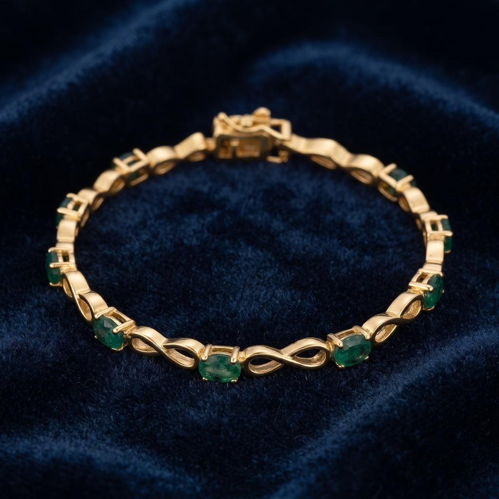 Natural emerald bracelet for women featuring oval green emeralds and infinity links in 925 sterling silver with 18K gold vermeil.