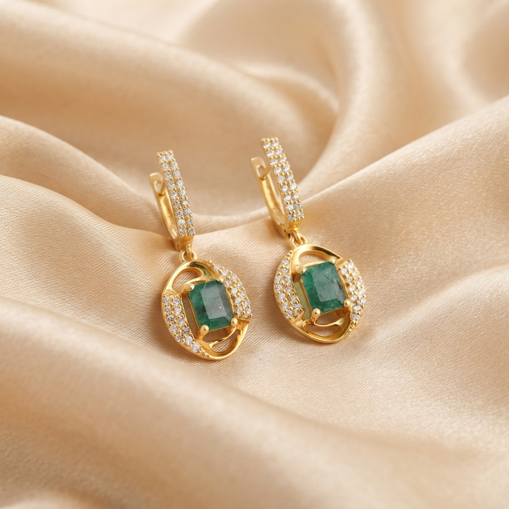 Natural emerald drop earrings by Ganpati featuring octagon emerald halo and leverback dangle setting in sterling silver with gold vermeil