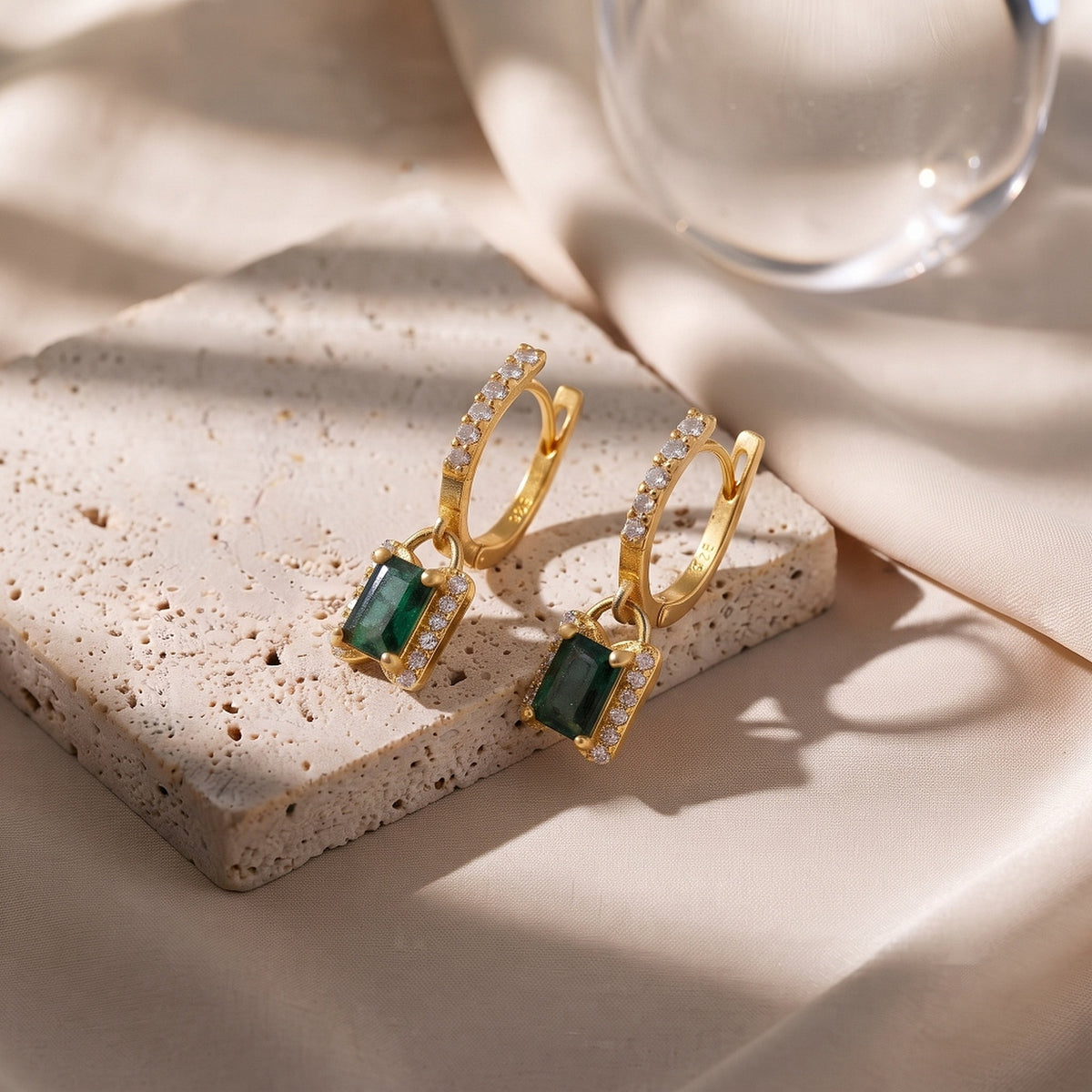 Gold vermeil emerald CZ charm drop earrings with octagon-shaped green gemstones and leverback dangles by Ganpati.