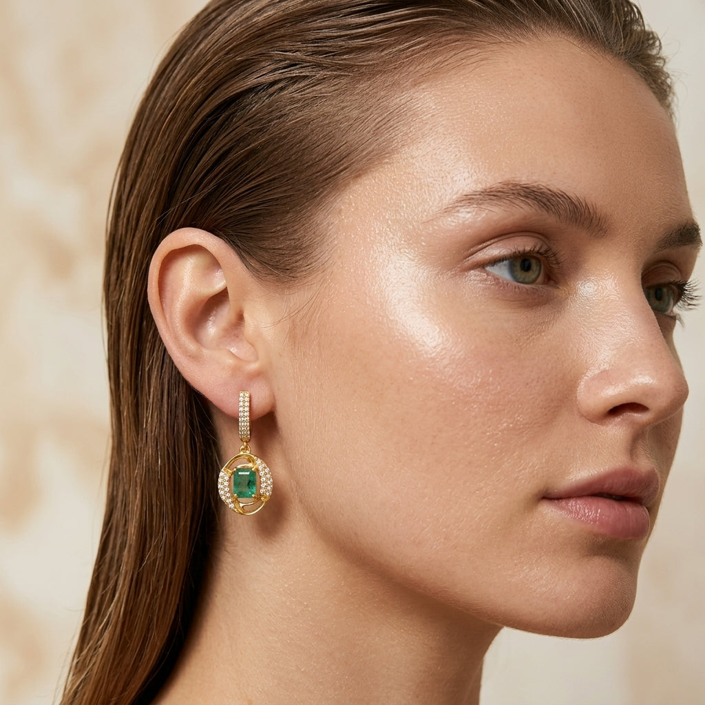 Model wearing Ganpati natural emerald drop earrings with octagon emerald halo, sterling silver gold vermeil leverback dangle earrings