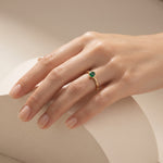 Model wearing Ganpati natural emerald bezel ring in gold vermeil with 925 silver, featuring a round emerald solitaire and minimalist design.